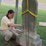 Using a tripod hoist to reset a marble headstone