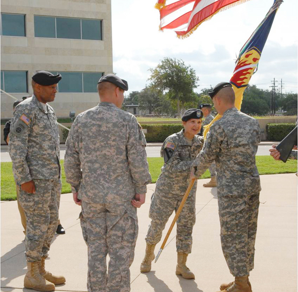 Colonel Maria Zumwalt, the incoming commander for the 48th Chem. Bde., passes the colors to Command Sgt. Maj. Kenneth Graham during the change of command ceremony at III Corps Headquarters June 10. (U.S. Army photo by Spc. Jenine Shamieh)