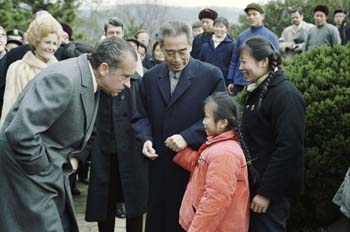 President Nixon greets a young Chinese girl during a visit to West Lake Park in Hangchow.