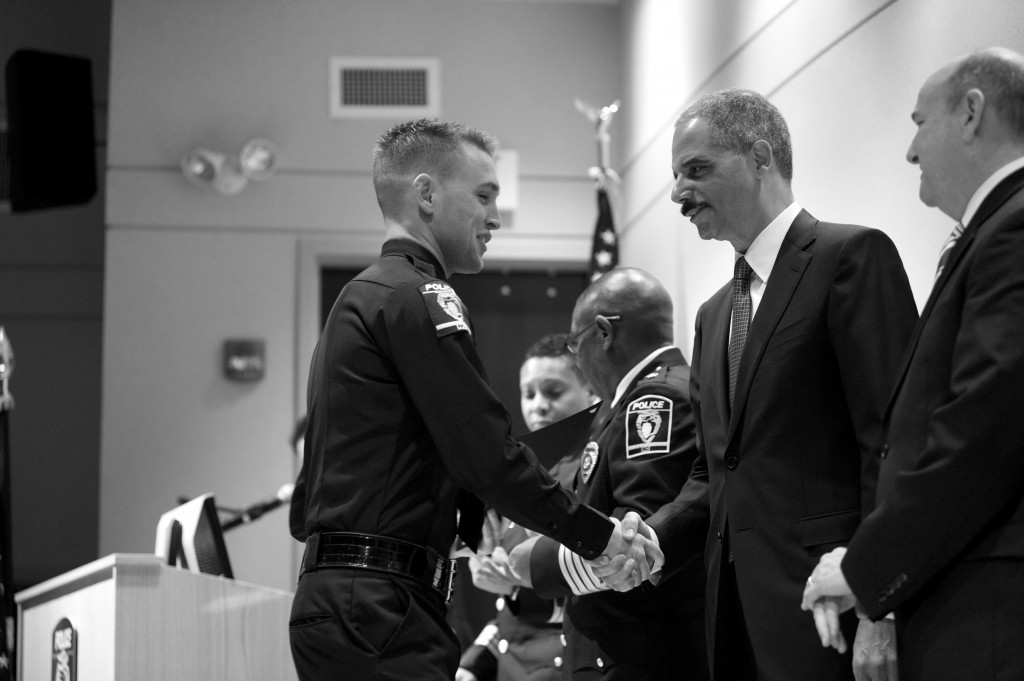 Attorney General Holder Congratulates a Graduating Officier