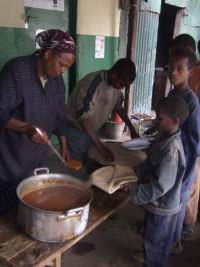 children being served in a food line