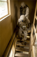 Marines of Company K, Battalion Landing Team (BLT) 3/2, currently reinforcing the 26th Marine Expeditionary Unit (MEU), move an enemy prisoner of war downstairs during the mechanized raid course at Camp Lejeune, N.C., Oct. 10, 2012. BLT 3/2 is one of the three reinforcements of 26th MEU, which is slated to deploy in 2013.