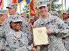 Brig. Gen. Gwen Bingham, U.S. Army Quartermaster General commandant, U.S. Army Quartermaster School, left, presents Lt. Col. Eric Schwartz, commander, 299th BSB, the 2012 Distinguished Unit of the Quartermaster Regiment certificate June 14 at Fort Lee, Va.  COURTESY PHOTO