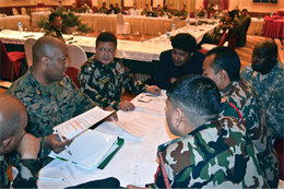 Maj. Jason Johnson discusses courses of action for responding to a simulated earthquake with members of the government of Nepal, Nepalese Army and U.S. Army Pacific Feb. 5 in Katmandu, Nepal, during the Nepal humanitarian assistance and disaster relief table-top exercise. The purpose of the exercise, conducted Feb. 2-8, was to improve III Marine Expeditionary Force’s ability to respond to an HADR scenario in Nepal through coordination and planning with the government of Nepal, U.S. Departments of Defense and State, international and national agencies, and multinational parties. Johnson is a civil affairs officer with III MEF. 