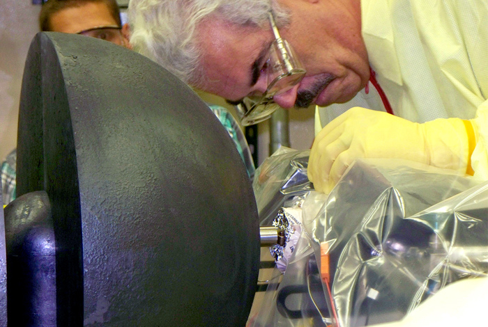 John Bounds of Los Alamos National Laboratory's Advanced Nuclear Technology Division makes final adjustments on the DUFF experiment, a demonstration of a simple, robust fission reactor prototype that could be used as a power system for space travel. DUFF is the first demonstration of a space nuclear reactor system to produce electricity in the United States since 1965.