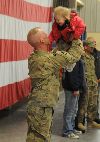 FORT RILEY, Kans.—Staff Sgt. Michael Davis, an infantryman of A. Co., 2nd Battalion, 16th Infantry Regiment, 4th Infantry Brigade Combat Team, 1st Infantry Division, swings his daughter Alexis Lynn through the air as the two come together once again on Feb. 5 following a brief Welcome Home Ceremony. Davis’s daughter was seven months old when he and the rest of the brigade deployed to Eastern Afghanistan last year. Over the nine month deployment his daughter more than doubled in age and is now 16 months old. (U.S. Army photo by Sgt. Scott Lamberson, 4IBCT PAO.) 