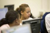 Two girls working in computer lab