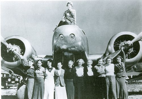 Aviation pioneer Amelia Earhart with a few of her students, in 1936. Click through for image source.