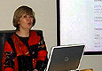 A woman standing at a computer. State Dept. photo