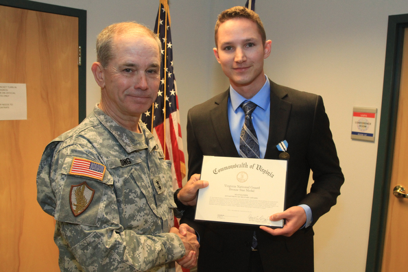 Maj. Gen. Daniel E. Long, Jr., the Adjutant General of Virginia, recognizes Sean Kanipe, an energy conservation specialist in the Facilities Management Office, with the Virginia Bronze Star Feb. 13, 2013, at Fort Pickett.  Long recognized seven state employees for their outstanding service to the Virginia National Guard and the Commonwealth of Virginia. (Photo by Cotton Puryear, Virginia National Guard Public Affairs)