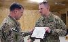 Maj. Gen. William Mayville, commanding general, CJTF-1 and the 1st Inf. Div., left, presents Capt. Daniel McDougall, commander, Co. A, STB, 4th IBCT, a certificate awarding his unit the Combat Action Streamer Jan. 16 at FOB Sharana, Afghanistan.  Photo by: Sgt. Gene Arnold, 4TH IBCT.