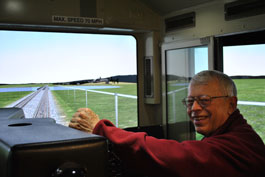 John K. Pollard of the Volpe Center's Human Factors Research and System Applications Center of Innovation operating the simulator.