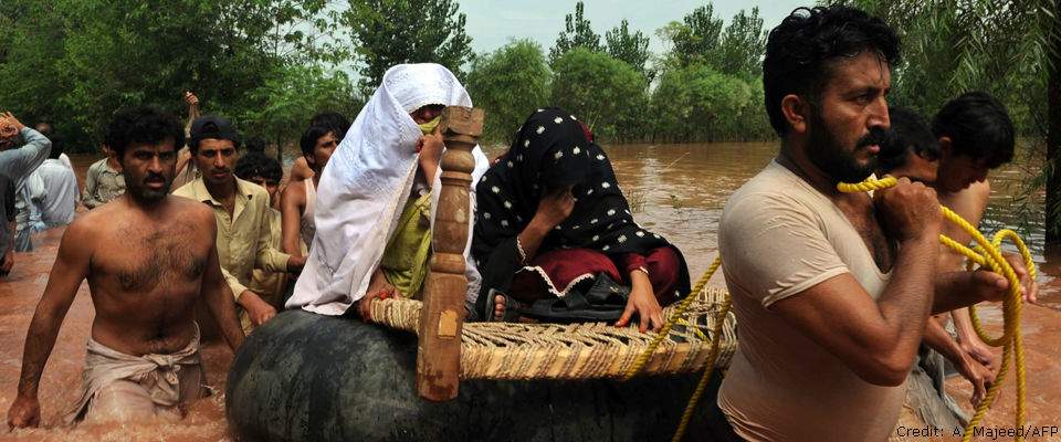 Residents evacuate to safety in a flood-hit area of Nowshera, Pakistan on July 30, 2010.