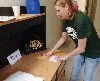 Sherri Laird, volunteer, 2nd Bn., 16th Inf. Regt., sets up barracks rooms for Soldiers who will soon be redeploying following a nine-month deployment to Afghanistan. Laird, along with other volunteers, made beds, hung shower curtains and prepared the rooms for the return of the Soldiers. In all, the volunteers prepared about 240 rooms.  Photo by: Sgt. Scott Lamberson, 4TH IBCT.