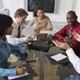 people in a meeting at a large desk