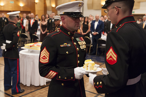 The youngest Marine has the first slice of cake.