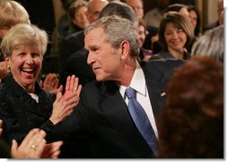 President George W. Bush reaches into the audience to shake hands with invited guests and staff members following his farewell address to the nation Thursday evening, Jan. 15, 2009 in the East Room of the White House, where President Bush thanked the American people for their support and trust.  White House photo by Joyce N. Boghosian