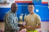 CAMP ARIFJAN, Kuwait (April 23, 2011) – Lt. Col. Robert Bland (left), who serves as the Army Reserves Affairs deputy assistant chief of staff with Third Army, and a native of Rice, Va., presents Staff Sgt. Long Tran, a biomedical and container management noncommissioned officer with the 3rd Medical Deployment Support Command, Third Army, a first-place medal for completing the Army Reserve Birthday Run at Camp Arifjan, Kuwait, April 23. Tran, a native of Virginia Beach, Va., placed first in the 5K run, finishing in 17:55:00. Photo by Spc. Eric Guzman, Third Army Public Affairs. VIRIN: 20110423-A-5706G-014