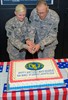 CAMP ARIFJAN, Kuwait (April 23, 2011) – Col. Ronald Newman (right), who serves as the strategic planner with the Army Materiel Command and a native of Green Valley, Ariz., and Spc. Brittany Burleigh, who serves as a mine-resistant ambush-protected vehicle driver with the 217th Transportation Company, 718th Transportation Battalion, 1st Sustainment Brigade, and a native of Waverly, Ohio, make the symbolic first cut into the Army Reserve birthday cake at Camp Arifjan, Kuwait, April 23, celebrating 103 years of the Army Reserves. Newman, 63, and Burleigh, 19, represent the youngest and oldest Army Reserve Soldiers stationed at Camp Arifjan. Photo by Sgt. Ryan Hohman, Third Army Public Affairs. VIRIN: 110423-A-1139H-008