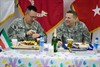 CAMP ARIFJAN, Kuwait (April 25, 2011) – Maj. Gen. Peter M. Vangjel (right), who serves as the Third Army deputy commanding general, speaks with retired 1st Lt. Jim Kirchner, a native of Douglasville, Ga., during a dinner honoring Wounded Warriors at Camp Arifjan, Kuwait, April 25.  The dinner was the first stop during Operation Proper Exit. Operation Proper Exit is sponsored by the United Services Organization allowing wounded Troops and Veterans to retrace the last steps they took before being injured. Kirchner, who served with the Mortar Platoon, Headquarters and Headquarters Company, 1st Battalion, 108th Armor Regiment, 48th Brigade Combat Team, Georgia Army National Guard, suffered injuries in Iraq during Operation Iraqi Freedom in 2005. Photo by Sgt. Ryan Hohman, Third Army Public Affairs. VIRIN: 110424-A-1139H-008