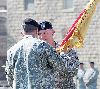 Col. Brian Tempest, commander, 1st Sust. Bde., right, accepts the 1st Sust. Bde. colors from Maj. Gen. William Mayville, 1st Inf. Div. and Fort Riley commanding general, left, during a change of command ceremony June 30. Tempest assumed command of the brigade from outgoing commander Col. Donnie Walker Jr.