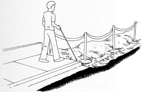 Figure 10-5. PROBLEM: Construction sites should include temporary ramps and should be blocked off with solid fencing. The thin tape in this illustration is not detectable using a long white cane.