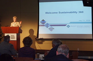 Mary Saunders giving her opening remarks for the Sustainability 360 event at utility Puget Sound Energy. PSE's 2008 energy efficiency work will result in annual savings for its customers of $30 million a year.
