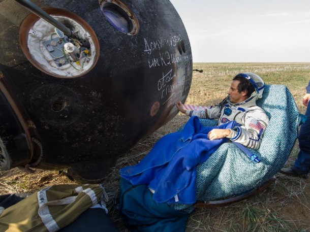 NASA Flight Engineer Joe Acaba signs the side of his Soyuz TMA-04M spacecraft that brought him and his crew mates back to Earth on September 17, 2012.  Acaba, along with Gennady Padalka and Sergei Revin of Russia returned from four months on board the International Space Station where they served as members of the Expedition 31 and 32 crews. (Photo: NASA/Carla Cioffi)