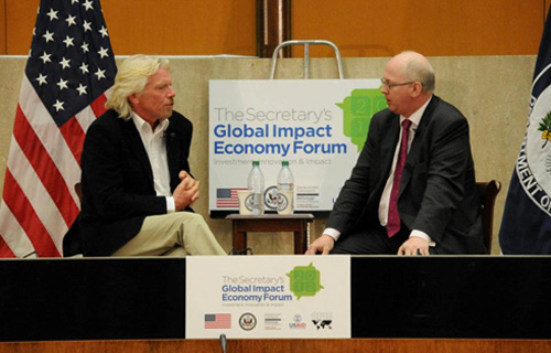 Matthew Bishop, New York Bureau Chief for The Economist talks with  Sir Richard Branson during the Secretary's Global Impact Economy Forum. State Department image.