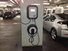 Photo of a car charging at an EV station.