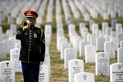 A bugler sounds taps during the remembrance ceremony for fallen medics