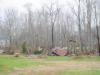 View of a metal shed that was destroyed with some of the debris carried into nearby trees to a height of over 20 feet  - Click to enlarge