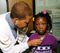 Doctor listens to young girl's heart