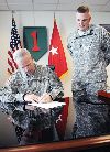 Brig. Gen. Donald MacWillie, senior commander, Fort Riley, left, signs a proclamation commemorating an educational observance for Law Day April 30 at 1st Infantry Division headquarters with Capt. Brian Kargus of the post’s Office of the Staff Judge Advocate.  Law Day was established by President Eisenhower in 1958 to mark the nation’s commitment to the rule of law, according to information from Fort Riley’s SJA office.  In 1961, Congress issued a joint resolution designating May 1 as the official date for celebrating Law Day.  Since then, each president has signed a proclamation similar to the one MacWillie signed.  To celebrate the commitment to the rule of law, attorneys, paralegals and staff at the SJA office visited on-post fifth grade classes through May 3 to demonstrate the importance of the court system.  Photo by Amanda Kim Stairrett, 1ST INF. DIV.