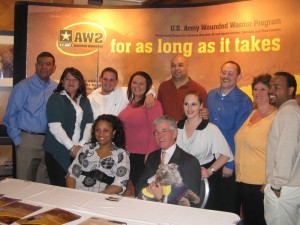 AW2 delegates gather with the Honorable John McHugh, Secretary of the Army, holding Starsky, an AW2 Veteran’s service dog after the AFAP closing ceremony.