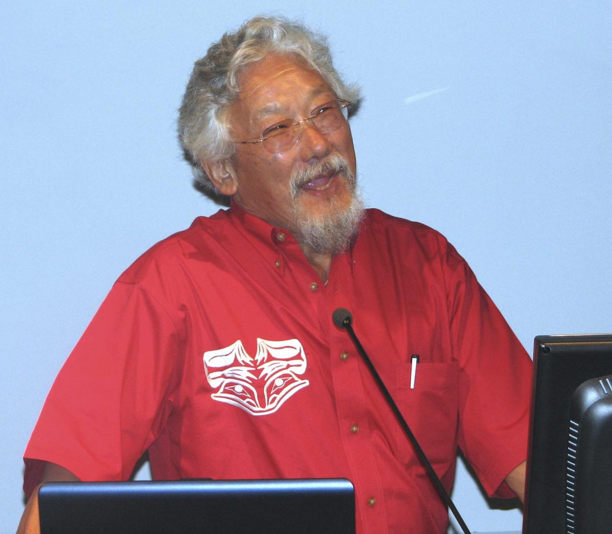 Photo of a man’s upper body as he gives a speech