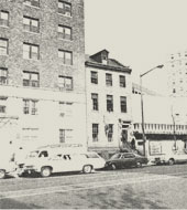 The area of the "Six Buildings" as it was in 1977, showing the only remaining original building at center.