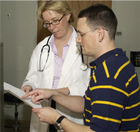 A patient looking at his chart with his doctor. - Click to enlarge in new window.