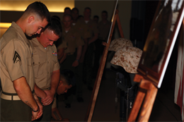 Marines with 9th Engineer Support Battalion pause to remember Cpl. Michael J. Palacio and Lance Cpl. Kenneth E. Cochran during a memorial service at the Camp Hansen Theater June 21. Palacio served as a military policeman and Cochran served as a water support technician with 9th ESB, which is part of 3rd Marine Logistics Group, III Marine Expeditionary Force.
