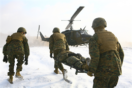 Marines and sailors with 3rd Battalion, 12th Marine Regiment transport a casualty to an awaiting Japan Ground Self-Defense Force UH-1 Iroquois helicopter during a bilateral evacuation exercise at the Hijudai Maneuver Area, Japan, Feb. 9. Casualty evacuation training is a requirement prior to any artillery relocation training live fire. The JGSDF provided air evacuation assets for both the mock casualty evacuation and Artillery Relocation Training 11-4. 3rd Bn., 12th Marines, is part of 3rd Marine Division, III Marine Expeditionary Force.