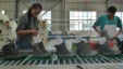 People work on the assembly line at a shoe factory in Dukem, Ethiopia, April 19, 2012.