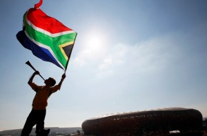 Picture of man holding a South African flag