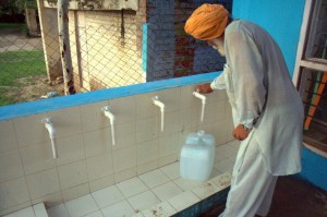 A villager in a remote region of India picks up his daily supply of clean drinking water