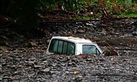 Pickup truck buried in flood sediments from Hurricane Irene (Photo Credit: FEMA/Adam DuBrowa)