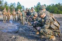 Marines prepare a ditching shot, January 10 at Engineer Training Area 3, under the supervision of an instructor to ensure safety for the Marines and that the charge is properly put together. Marines practiced the basics before moving on to other portions of the range. Practicing the basics is what allows for them to build on and advance in their knowledge of different explosives and their many uses.