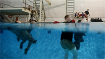 Sgt. Seth Handy, an instructor of water survival, watches Marines during the water-treading portion of water survival training at Ramer Hall pool Jan. 12. While watching, he gave tips to the Marines on how to conserve energy. The Marine Corps’ water survival program ensures Marines can survive possible drowning situations such as going overboard a ship, during vehicle rollovers into a river or any other water-based emergency. 