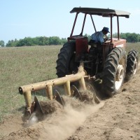 A tractor is used to prepare soil with disc plough preparation machinery