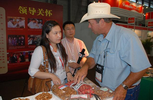 Tim Montz (right) of the Montz Pecan Company speaks with members of the Chinese media while displaying his Texas-grown products at the USDA-supported SIAL China food trade show in 2009. Participation in USDA events and export assistance from the Foreign Agricultural Service has helped international sales of Montz pecans thrive in recent years. Photo by Cindy Wise of the Texas Pecan Growers AssociationTim Montz (right) of the Montz Pecan Company speaks with members of the Chinese media while displaying his Texas-grown products at the USDA-supported SIAL China food trade show in 2009. Participation in USDA events and export assistance from the Foreign Agricultural Service has helped international sales of Montz pecans thrive in recent years. Photo by Cindy Wise of the Texas Pecan Growers Association