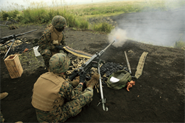 Cpl. Rander T. Haywood III, kneeling, a ground communications repairman with Headquarters Battery, 3rd Battalion, 12th Marine Regiment, 3rd Marine Division, III Marine Expeditionary Force, watches as his partner fires .50 caliber machine gun rounds down range during 12th Marines’ first day of firing crew-served weapons at the East Fuji artillery range during Artillery Relocation Training Program Exercise 2010-2, Sept. 12. More than 390 Marines and sailors from 12th Marines, as well as 116 personnel from Mike Battery, 3rd Bn., 11th Marine Regiment (Reinforced), 31st Marine Expeditionary Unit, III MEF, have been participating in Artillery Relocation Training Program Exercise 2010-2 here since Sept. 4.