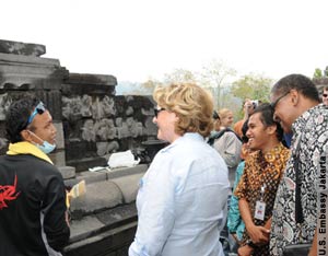 Judith McHale and other people talking in front of temple wall (U.S. Embassy Jakarta)